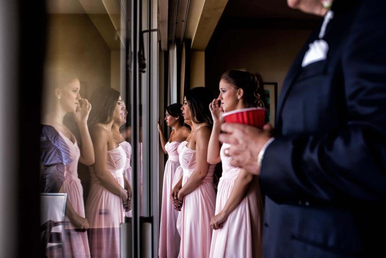A group of bridesmaids looks out the window
